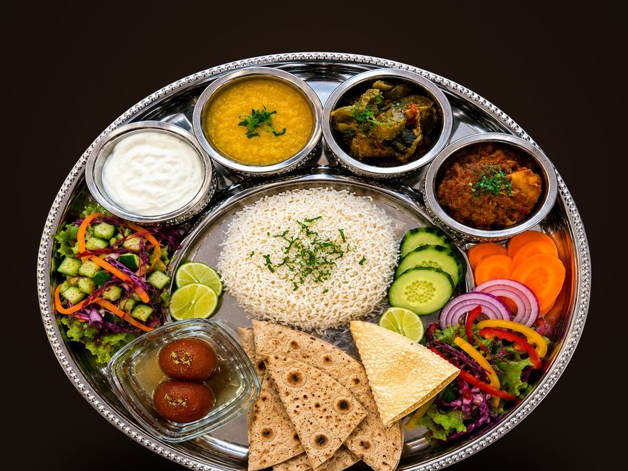 Traditional Nepalese thali set with dal, curry, naan and rice